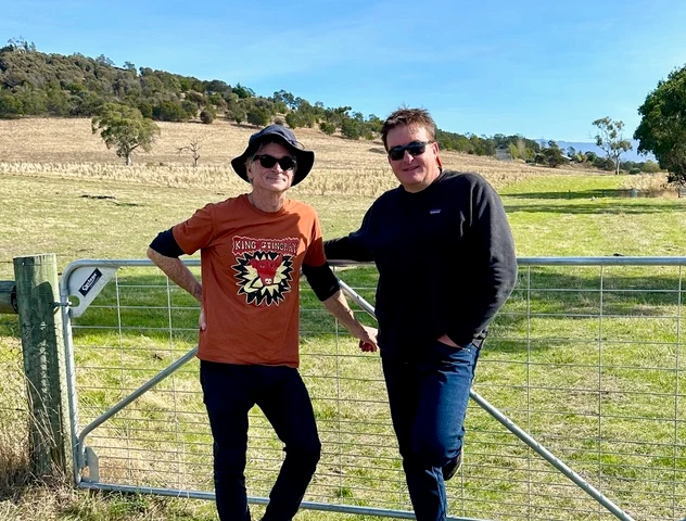 Decades_-_2_men_infront_of_farm_gate